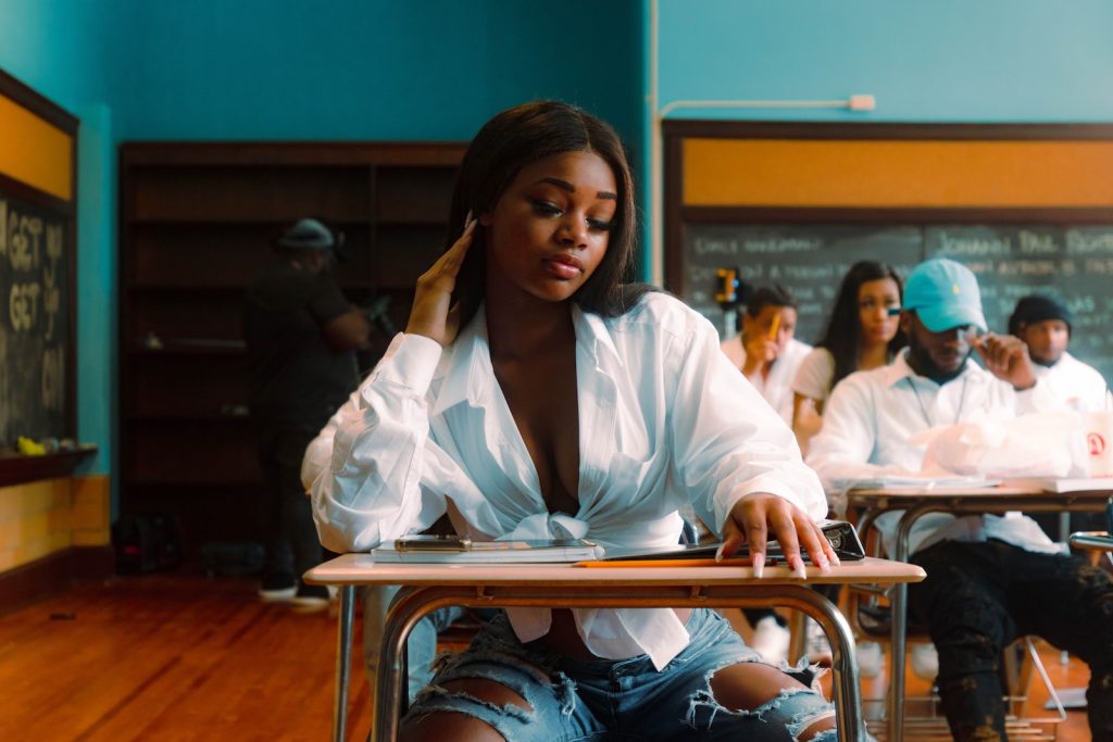 a woman sitting at a desk in a classroom